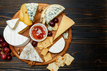 Various types of cheese - parmesan, brie, roquefort, cheddar