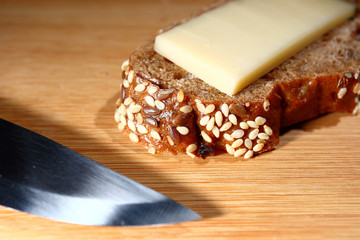 freshly baked multi-grain bread with cheese on wooden background