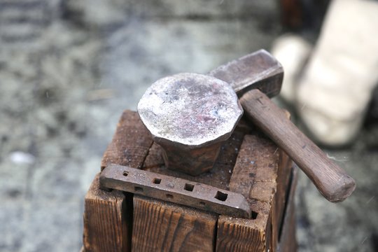 the table from wooden square bars, is specially collected by a bracket for forge affairs and on it an anvil and the hammer