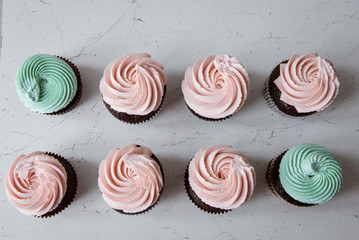 Tasty cupcakes on background table. Homemade chocolate muffin cupcake with cream buttercream icing. Birthday cupcake. Valentine cupcake sweets. Close up view delicious sweet dessert