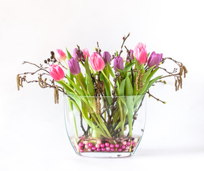 Spring bouquet of colorful tulips with willow twigs