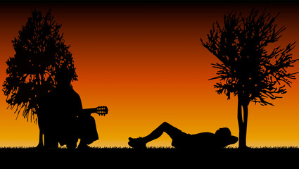 détente allongé dans un parc avec guitariste le soir