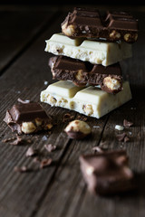 Chocolate bar of white and dark chocolate on wooden background