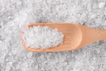 Sea salt in a wooden spoon.
