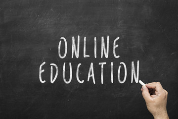 Fototapeta premium Inscription: Online education written on black chalkboard. Education concept.