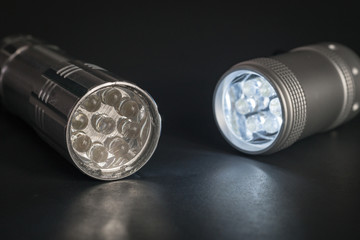 Two Flashlights, One on and One Off