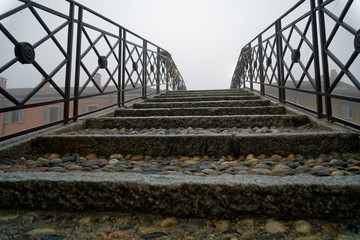 Bridge over the water canal in the autumn, haze weather, foggy morning in the national park