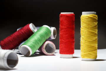Sewing Quilting Thread, Rainbow colors. on black background with place for your own text