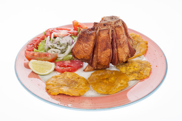 fried pork knuckle with salad and patacones