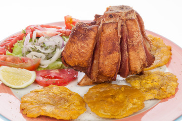 fried pork knuckle with salad and patacones