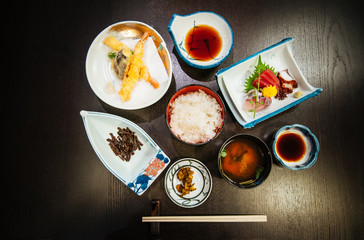 Local Japanese simple lunch set with tempura and fresh maguro tuna sashimi. Top view