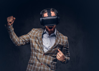 Studio portrait of a man wearing virtual reality glasses on a da