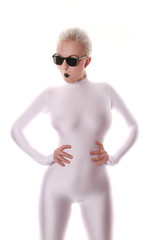 strange fashionable woman wearing white spandex fetish tight catsuit and black sunglasses posing on...