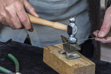 Making crafts with a small anvil and a hammer