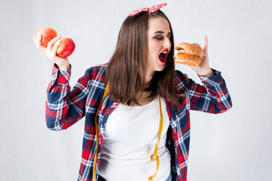 Unhealthy food fat woman concept, Hungry girl XXL eat bad food, Model plus size hold burgers centimeter female well-fed  with fatty stomach in shirt web design banner poster isolated place for text