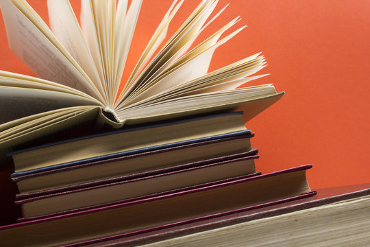 Open book, hardback books on wooden table. Back to school. Copy space