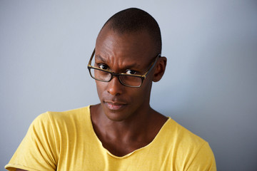 Fototapeta premium Close up african man with glasses against gray background