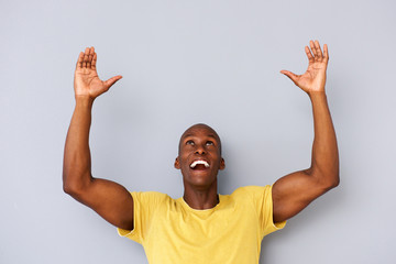 happy black man with arms and hands raised to lift - obrazy, fototapety, plakaty