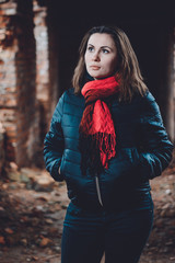 Beautiful young woman standing in a destroyed building in cold drowning