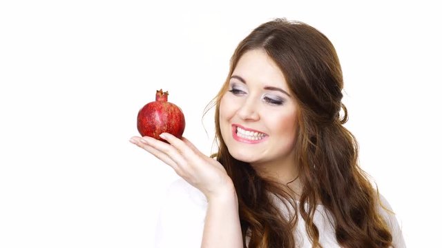 Woman cheerful brunette girl holding pomegranate fruit in hand, making thumb up sign, isolated on white. Healthy eating, cancer prevention, immune support."