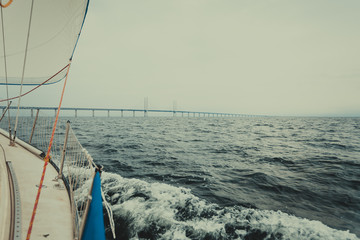 Fototapeta premium Yacht and oresund bridge between denmark sweden