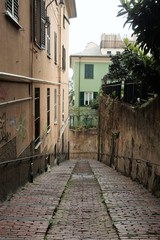 Fototapeta na wymiar a straight street in Genoa, Italy