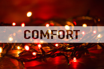 Text with the word Comfort as concept on lights background with bokeh effect. Conceptual.