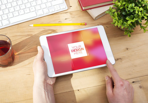 Mockup of Tablet User at Wooden Desk 2