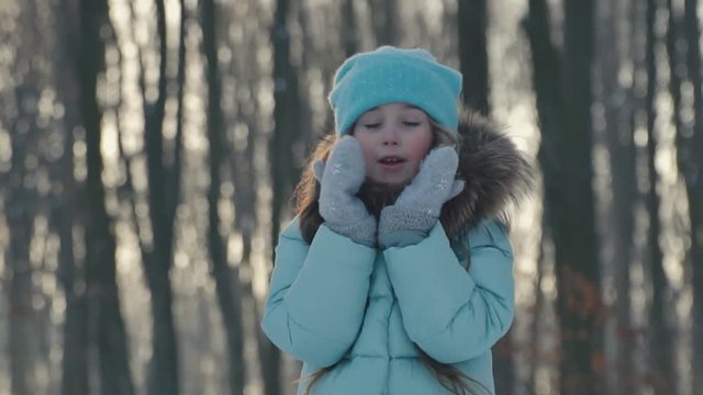 the little girl sends an air kiss