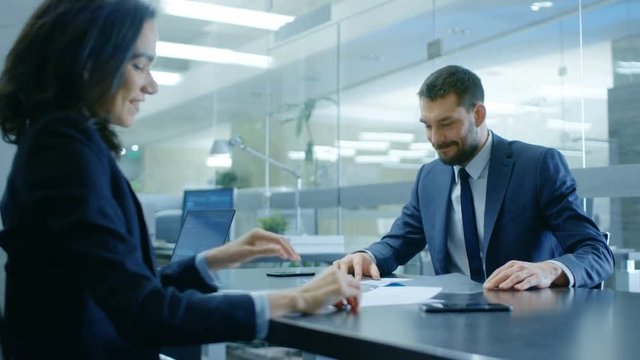 Businesswoman and Businessman Have Conversation. Draw up a Contract, Sign Documents, Seal the Deal, Finish Transaction, Come to an Agreement. Shot on RED EPIC-W 8K Helium Cinema Camera.