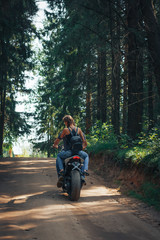 Fototapeta na wymiar The motorcyclist and the girl on the road