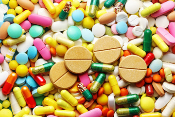 Fototapeta na wymiar A lot of colorful pills with big pills