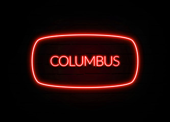 Columbus neon sign on brick wall background.