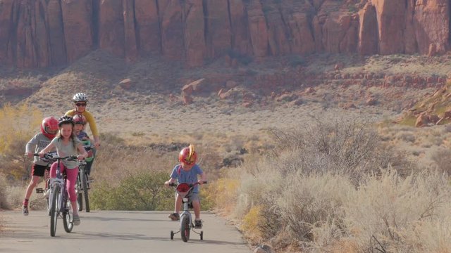 Mother and kids outside riding bikes in southern desert