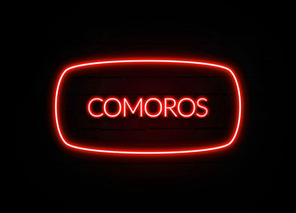 Comoros neon sign on brick wall background.