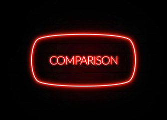 Comparison neon sign on brick wall background.