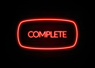 Complete neon sign on brick wall background.