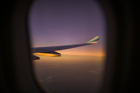Airplane wing seen through airplane window 