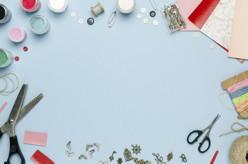 Tools and materials for creativity scattered on the table. Scrapbooking, creative mess. Empty space for text, top view