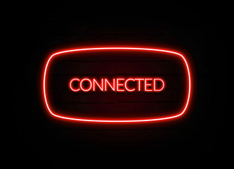 Connected neon sign on brick wall background.