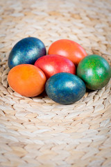 Easter coloured eggs on old basket