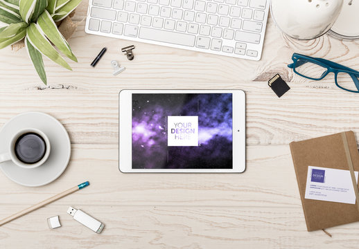 Tablet and Business Card at Wooden Desk with Accessories Mockup