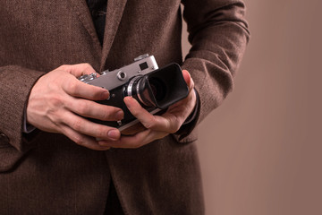 Man with retro camera in tweed vintage dress

