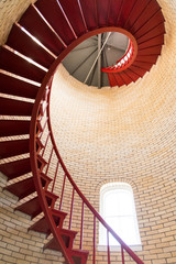 Red iron spiral staircase inside a lighthouse