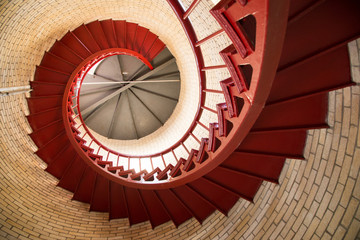 Obraz premium Red iron spiral staircase inside a lighthouse