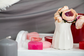 a vase and candles on the tray