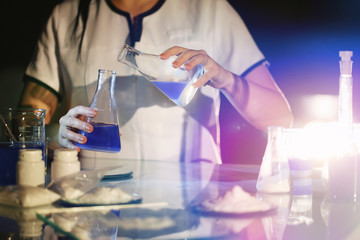 Female medical technologist working with chemicals in a research laboratory. Medical scientific equipment. Close-up