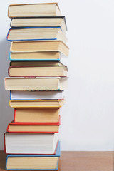 Stack of different books on a woogen table