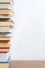 Stack of different books on a woogen table