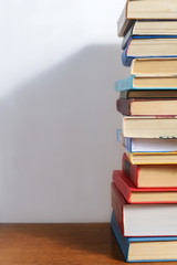 Stack of different books on a woogen table